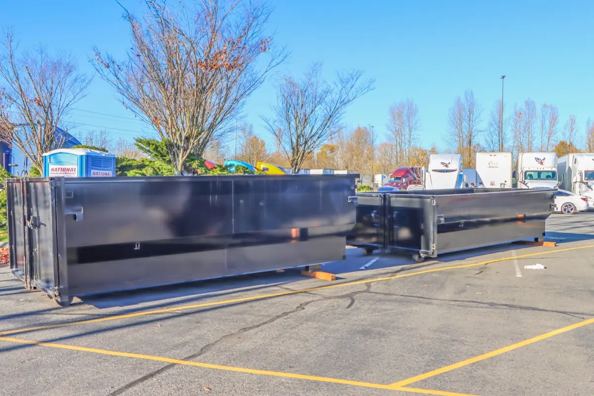 Professional dumpster rental service with roll-off container on residential driveway in Dacono